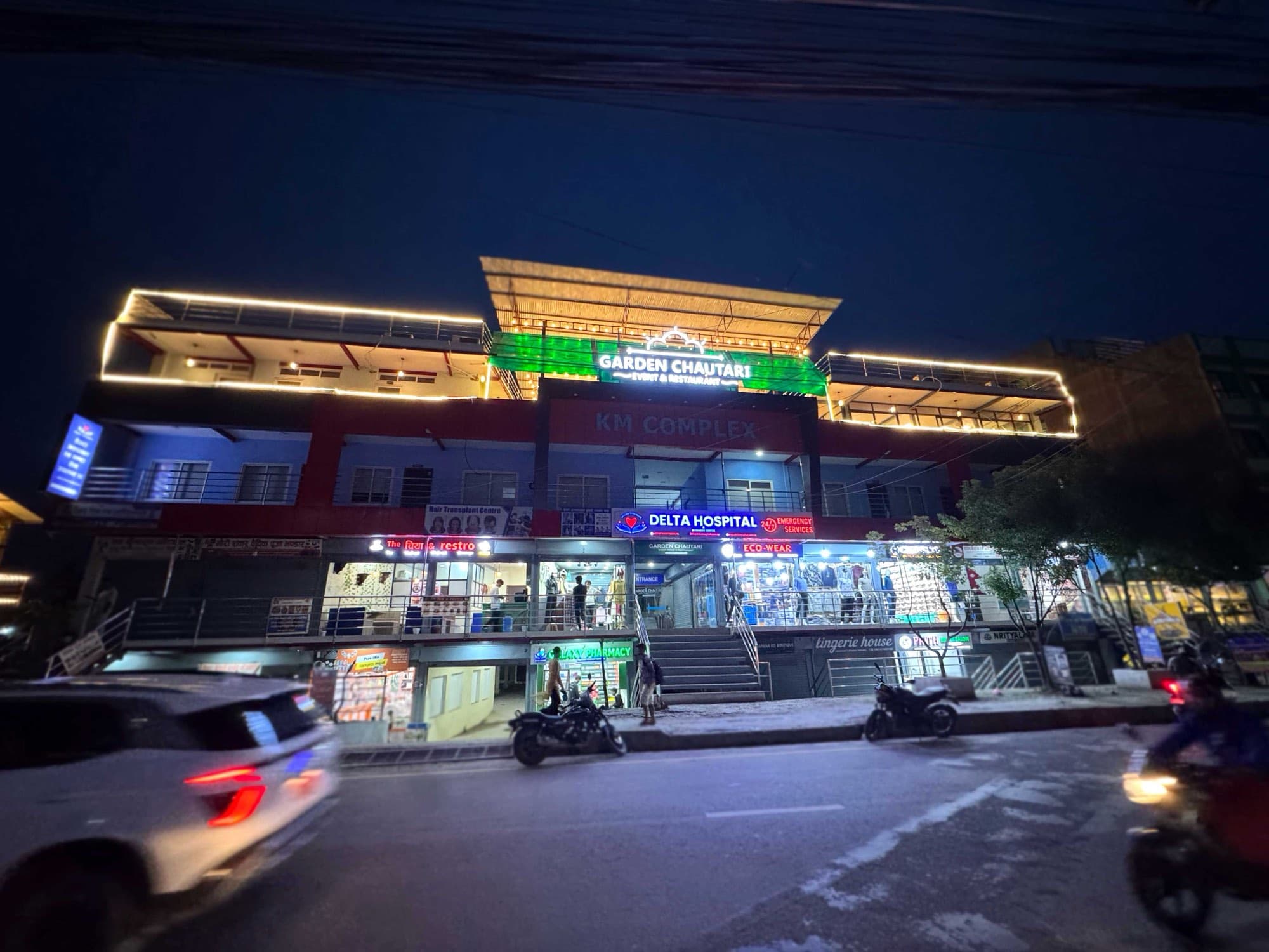 Garden Chautari lit up above the KM Complex at night